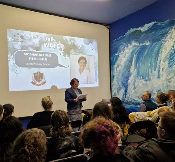 A person giving a presentation in the Aquarium, Galway.