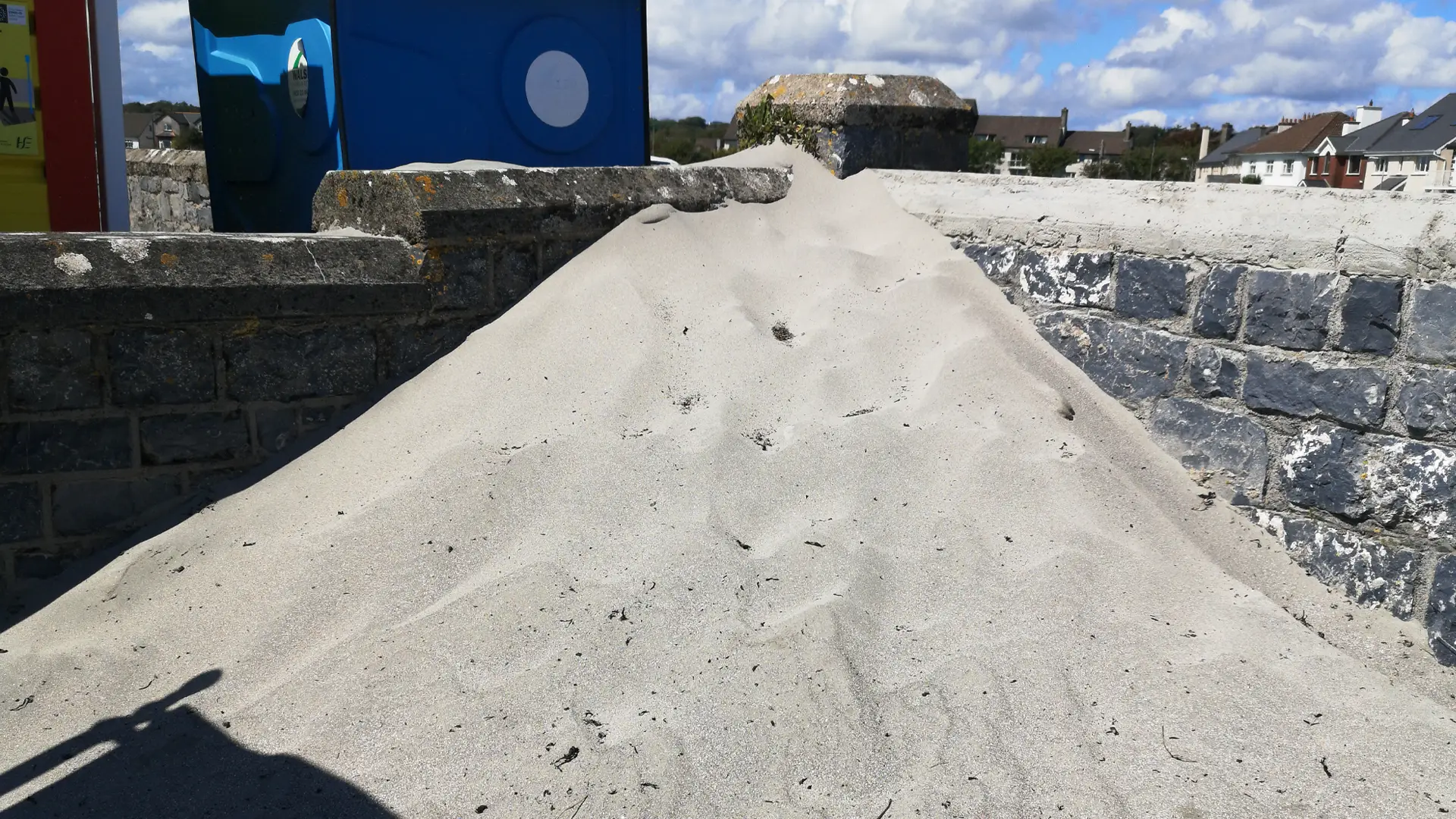 A big pile of sand piled up against a wall on Grattan Beach, Salthill.