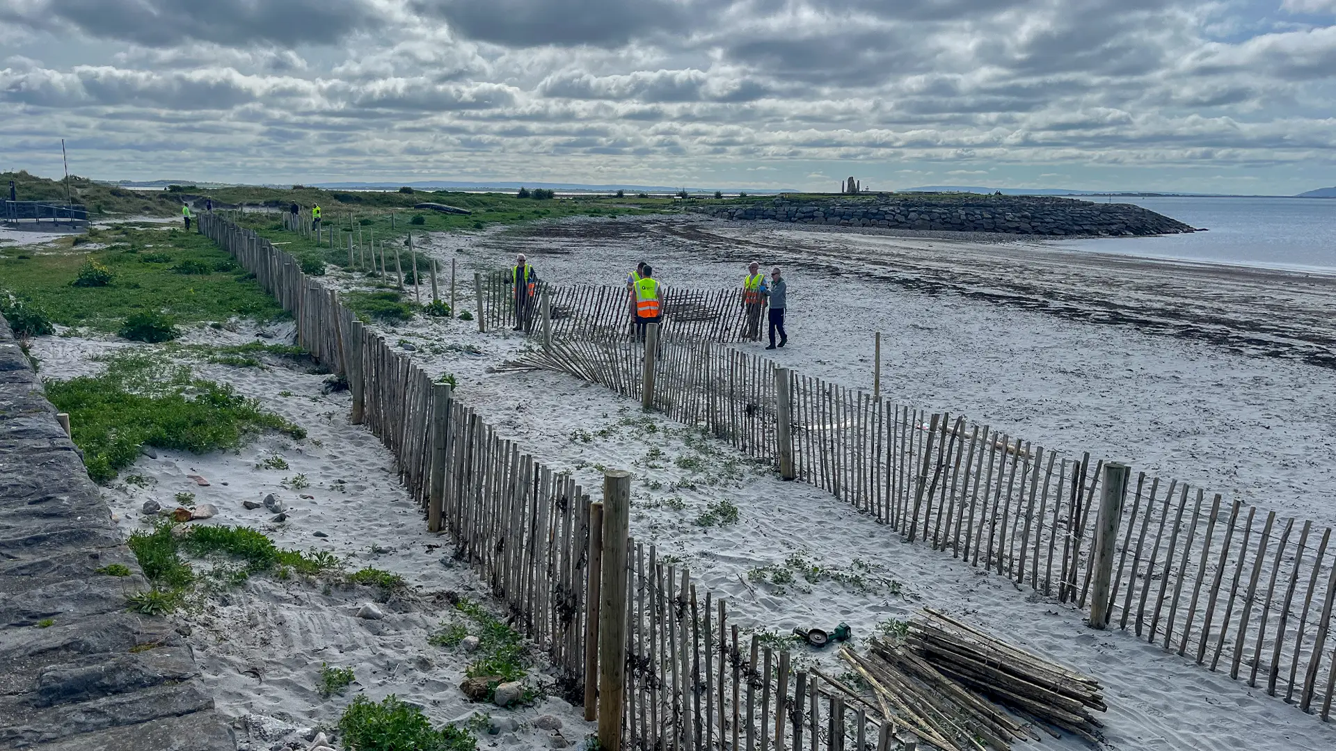 Install day with Galway City Council laying out the fences on the beach.